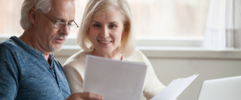 An older couple sat looking at paperwork