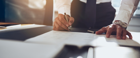 man signing legal papers